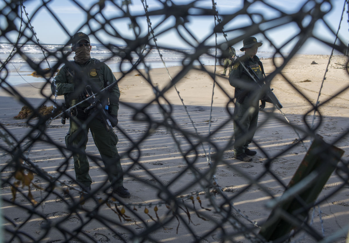 Border patrol agents arrive at the border fence after about a dozen people who traveled from Central America found a small hole in the United States border fence and squeezed their way onto the beach in the United States on December 3, 2018, at the US-Mexican border in Tijuana, Mexico.