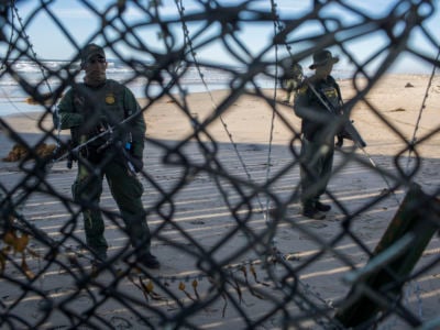 Border patrol agents arrive at the border fence after about a dozen people who traveled from Central America found a small hole in the United States border fence and squeezed their way onto the beach in the United States on December 3, 2018, at the US-Mexican border in Tijuana, Mexico.