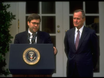 President George H.W. Bush listens to Deputy Attorney General William Barr at a White House portico ceremony announcing Barr's nomination to succeed Attorney General Dick Thornburgh on October 16, 1991, in Washington, DC.