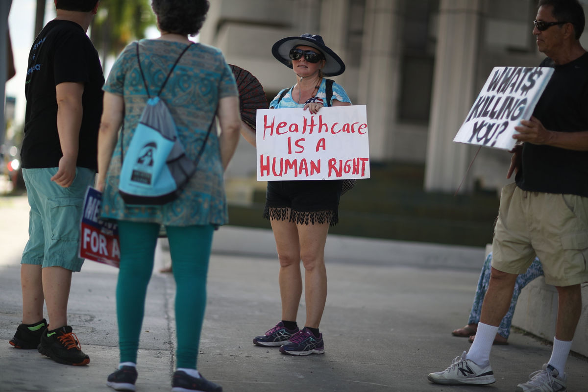 Katrina Greenwood joins with other protesters against Republican senators who have not spoken up against repealing the Affordable Care Act on July 24, 2017, in Fort Lauderdale, Florida.