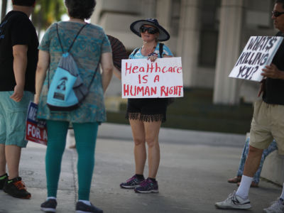 Katrina Greenwood joins with other protesters against Republican senators who have not spoken up against repealing the Affordable Care Act on July 24, 2017, in Fort Lauderdale, Florida.