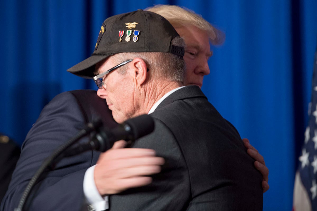 Donald Trump hugs Vietnam veteran Max Morgan as he participates in a veterans meet and greet on the sidelines of the Asia-Pacific Economic Cooperation leaders' summit in the central Vietnamese city of Danang on November 10, 2017.