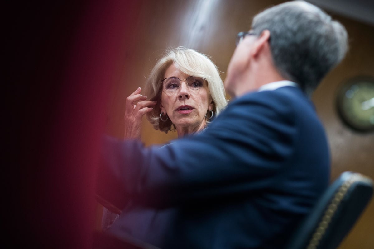 Education Secretary Betsy DeVos talks with with Bill Cordes of the department's Budget Service before testifying in front of a Senate subcommittee on the department's budget request for fiscal year 2019 on June 5, 2018.