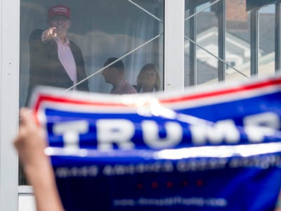 President Trump gestures to well-wishers at the Trump National Golf Course in Bedminster, New Jersey, July 16, 2017. It appears supervisors at the golf club employed undocumented immigrants and gave out fake green cards.