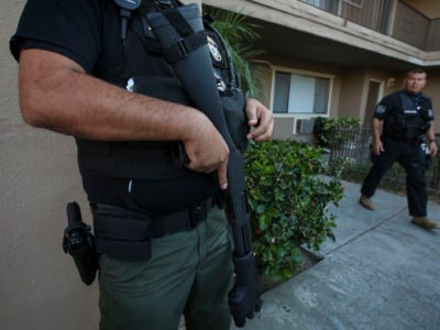 An Enforcement and Removal Operations unit with Immigration and Customs Enforcement conducts a raid in Riverside, California, August 12, 2015.