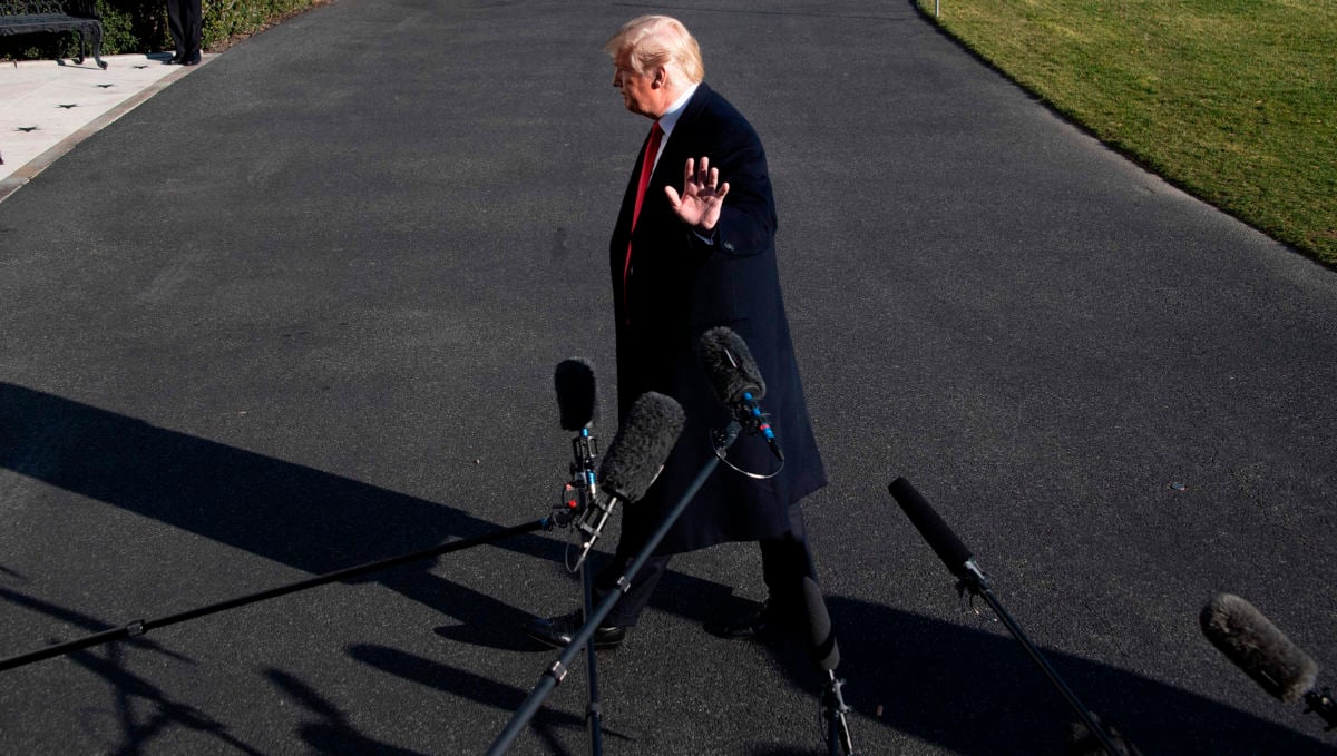 President Trump walks past the media as he arrives at the White House in Washington, DC, on January 6, 2019, as the government shutdown enters its third week.