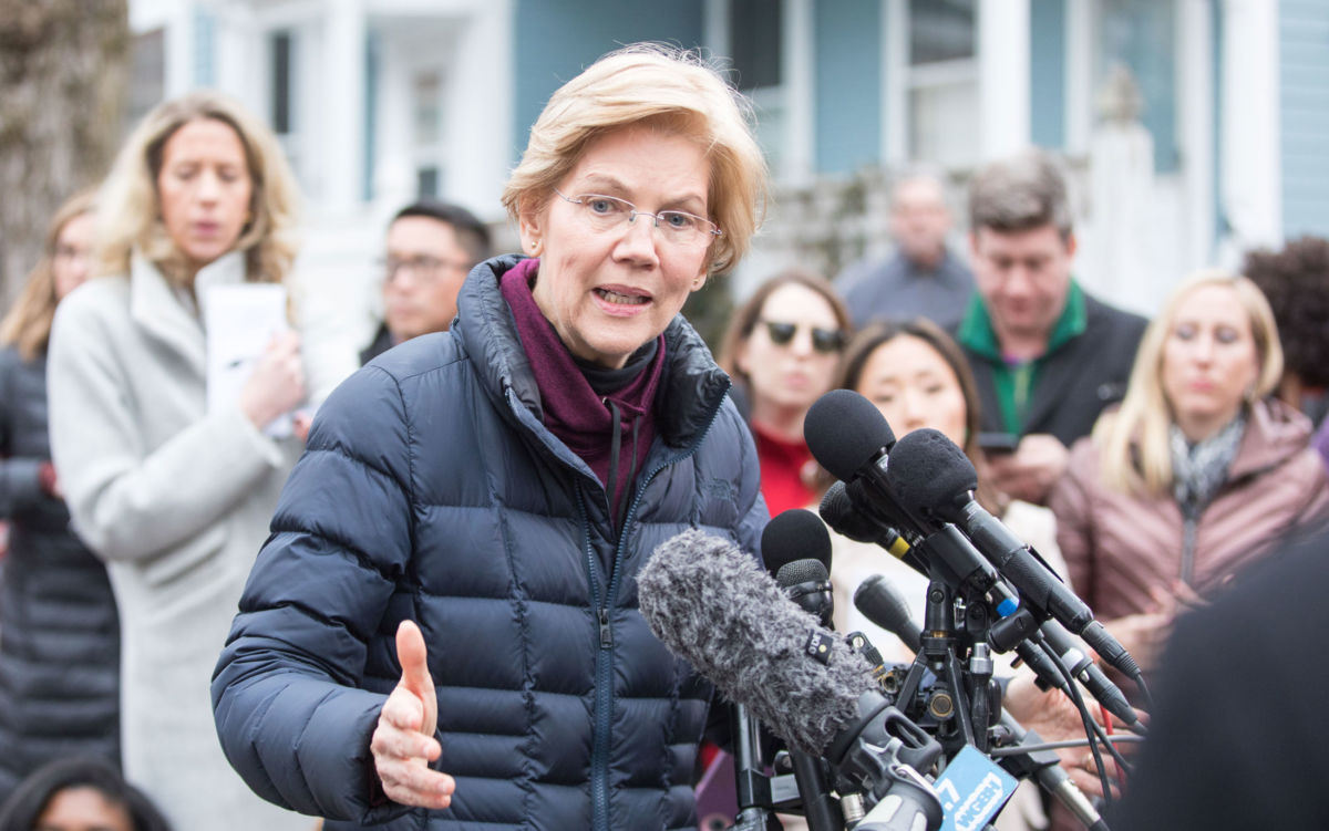 Sen. Elizabeth Warren addresses the media outside of her home after announcing she formed an exploratory committee for a 2020 presidential run on December 31, 2018 in Cambridge, Massachusetts.