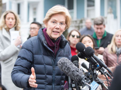 Sen. Elizabeth Warren addresses the media outside of her home after announcing she formed an exploratory committee for a 2020 presidential run on December 31, 2018 in Cambridge, Massachusetts.