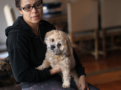 Transportation Security Administration (TSA) employee Rita Silva-Martins holds her dog, Mochi, in Natick, Massachusetts, on January 10, 2019. Because federal funding for the TSA lapsed on December 22, her paycheck is in danger. Unless a deal is brokered soon to reopen the government, her finances are on a collision course with President Trump's fight for $5 billion to build a wall on the southern border.