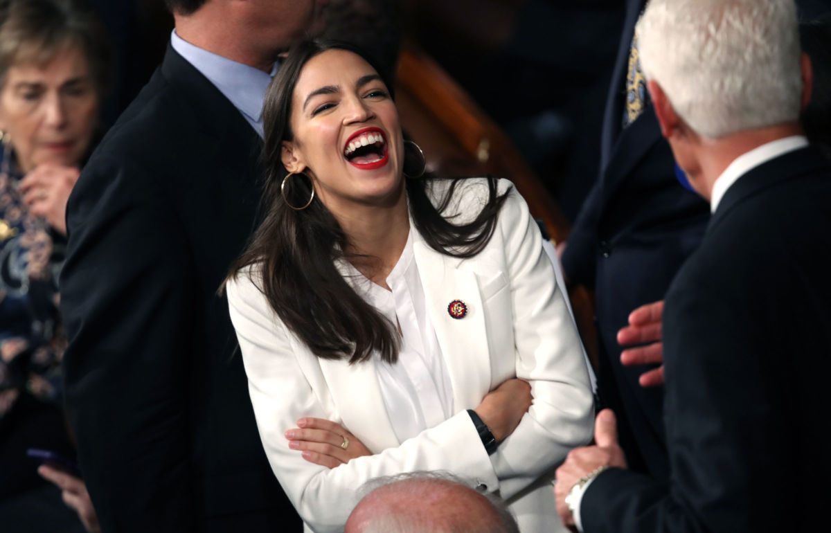 Rep. Alexandria Ocasio-Cortez (D-NY) talks to fellow members of Congress during the first session of the 116th Congress at the US Capitol January 3, 2019, in Washington, DC.