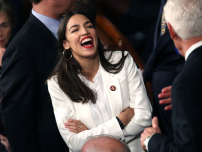 Rep. Alexandria Ocasio-Cortez (D-NY) talks to fellow members of Congress during the first session of the 116th Congress at the US Capitol January 3, 2019, in Washington, DC.