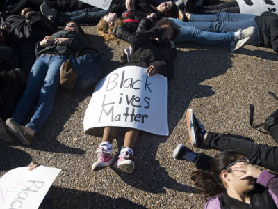 Students from School Without Walls High School march after performing a die-in on Pennsylvania Avenue in front of the White House in Washington, DC, December 17, 2014, demonstrating against police violence and human rights.