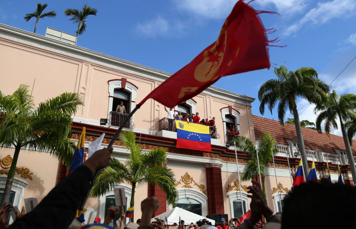 Venezuela's President Nicolás Maduro (C) greets his supporters during a gathering against oppositions' rallies in front of the Miraflores Palace in Caracas on January 23, 2019.