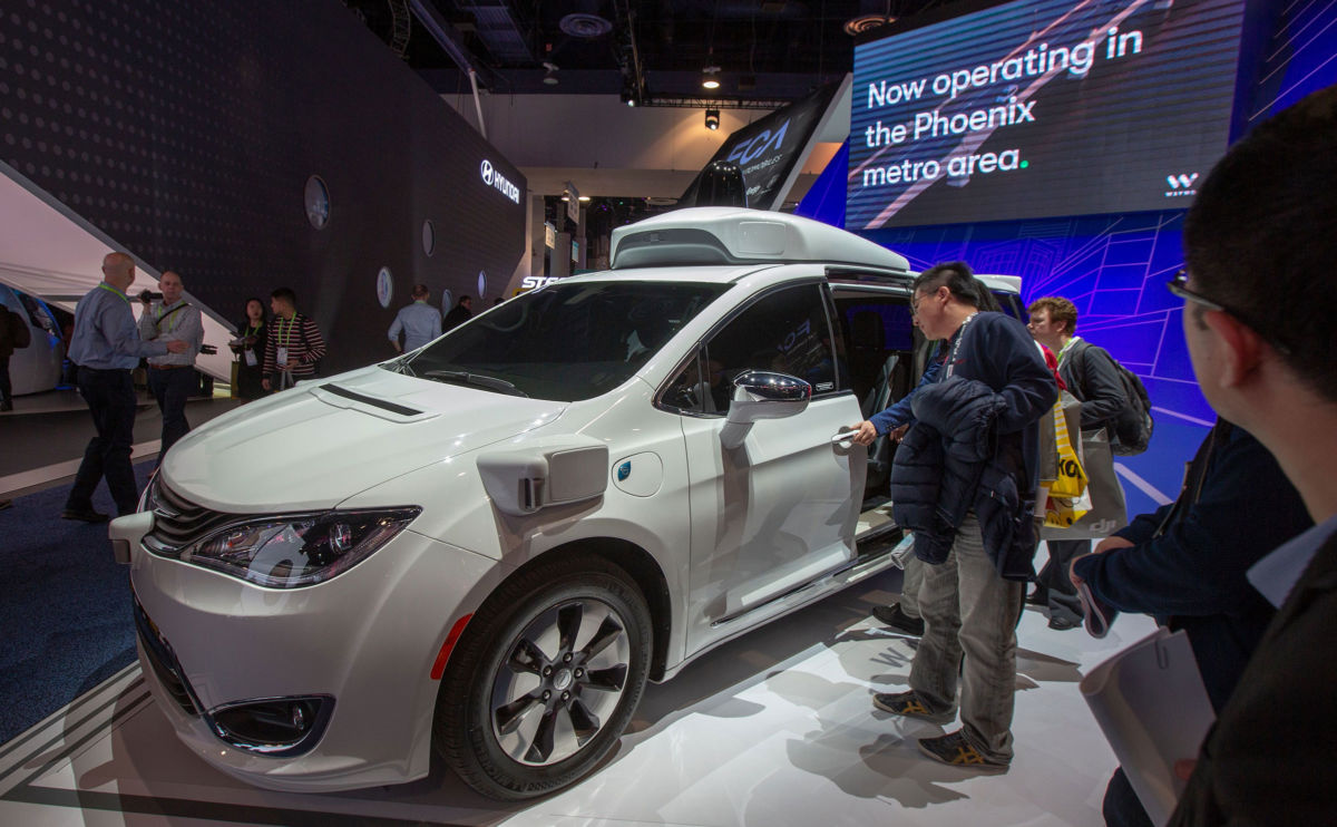 People look at the Waymo car, formerly the Google self-driving car project, during the Las Vegas Convention Center during CES 2019 in Las Vegas on January 9, 2019.