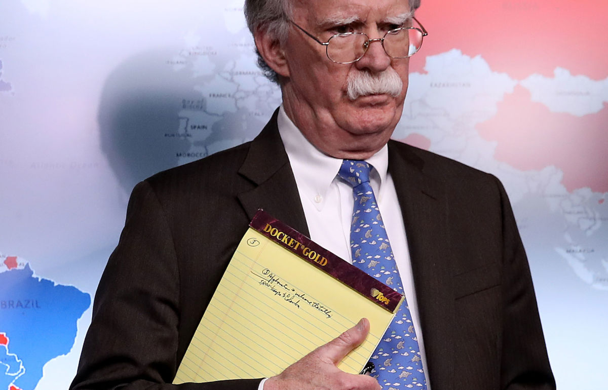 With handwritten notes on a legal pad, National Security Adviser John Bolton listens to questions from reporters during a press briefing at the White House January 28, 2019, in Washington, DC.
