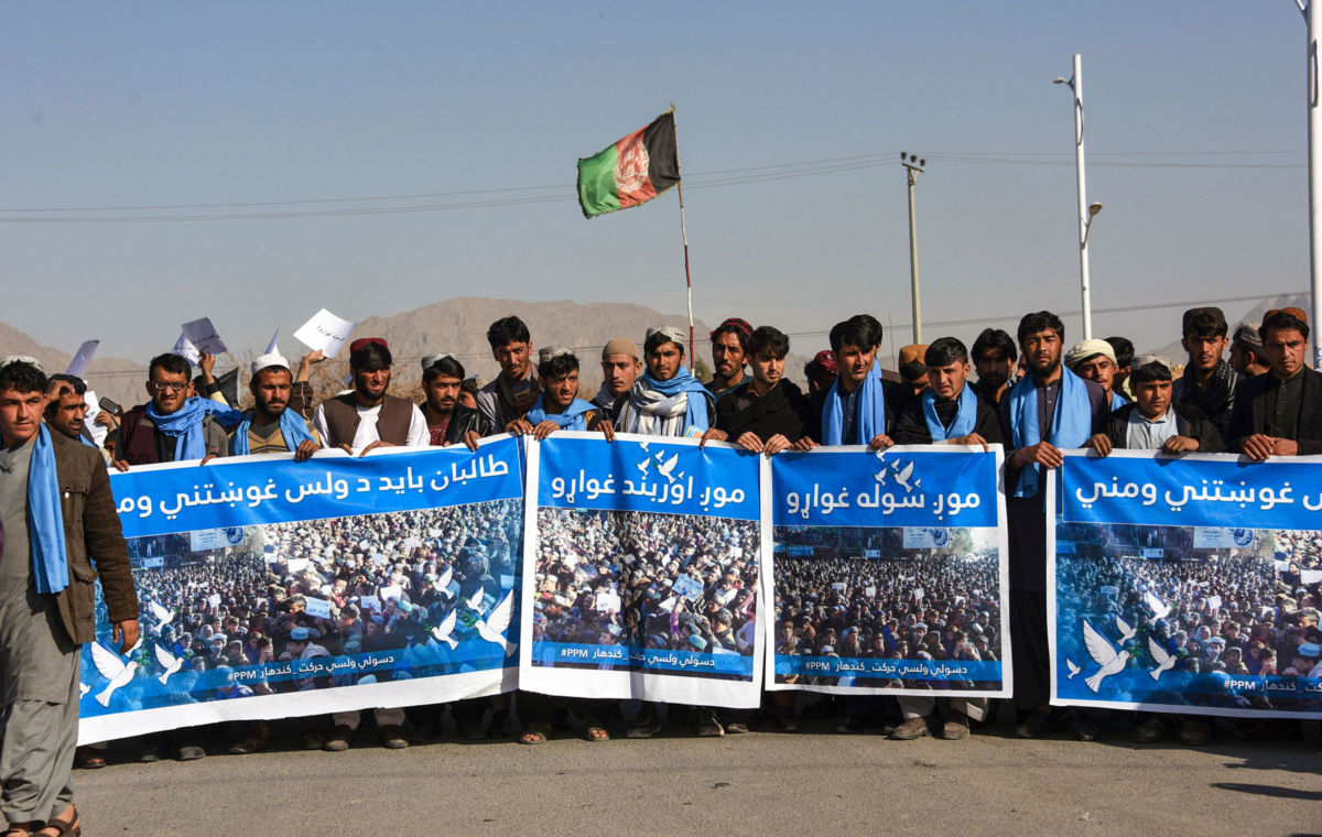 People's Peace Movement members march in the Kandahar Province on January 17, 2019, with banners reading: "No War," "We Want a Ceasefire" and "We Want Peace."