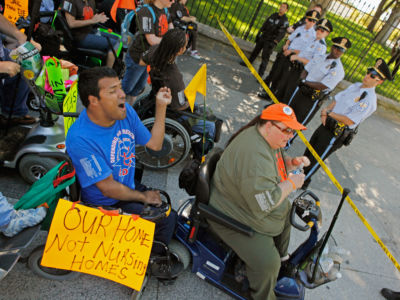 Protestors from ADAPT, a grassroots community that organizes disability rights activists to engage in nonviolent direct action, block the sidewalk along the north side of the White House, September 20, 2010, in Washington, DC.