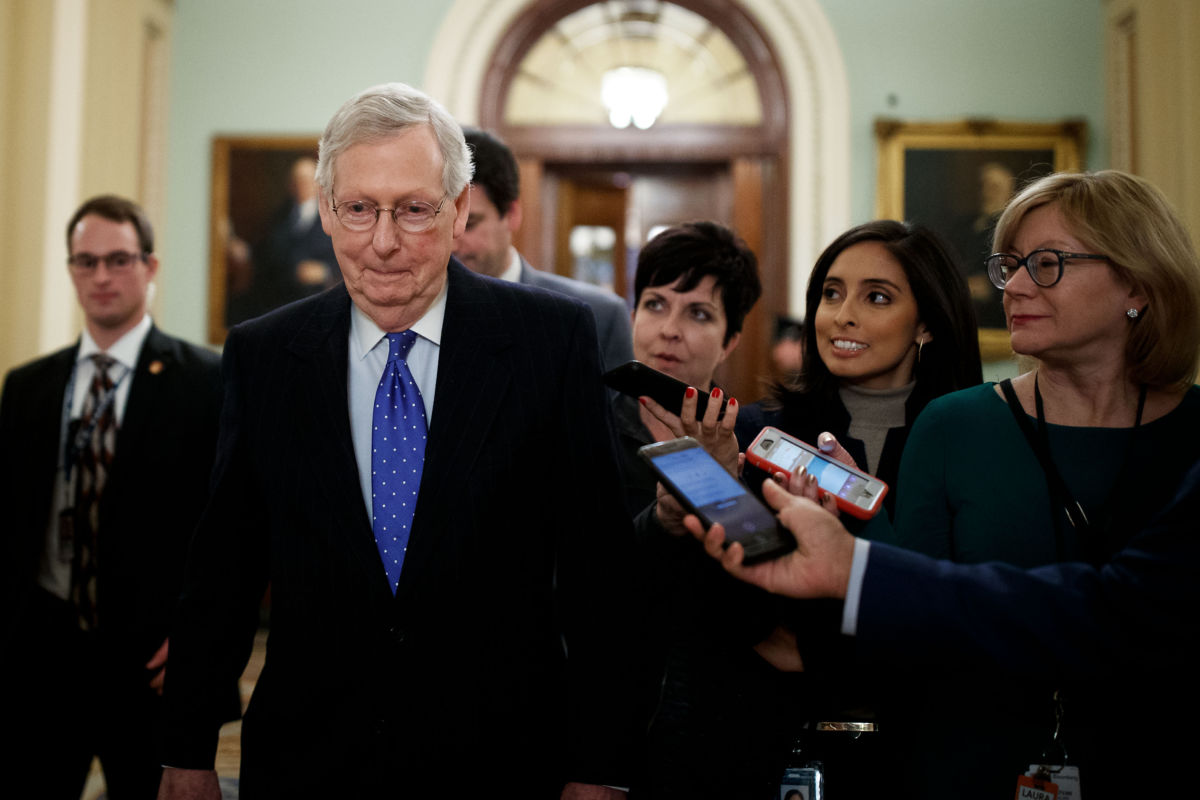 Reporters question US Senate Majority Leader Mitch McConnell at Capitol Hill in Washington, DC, on December 19, 2018.