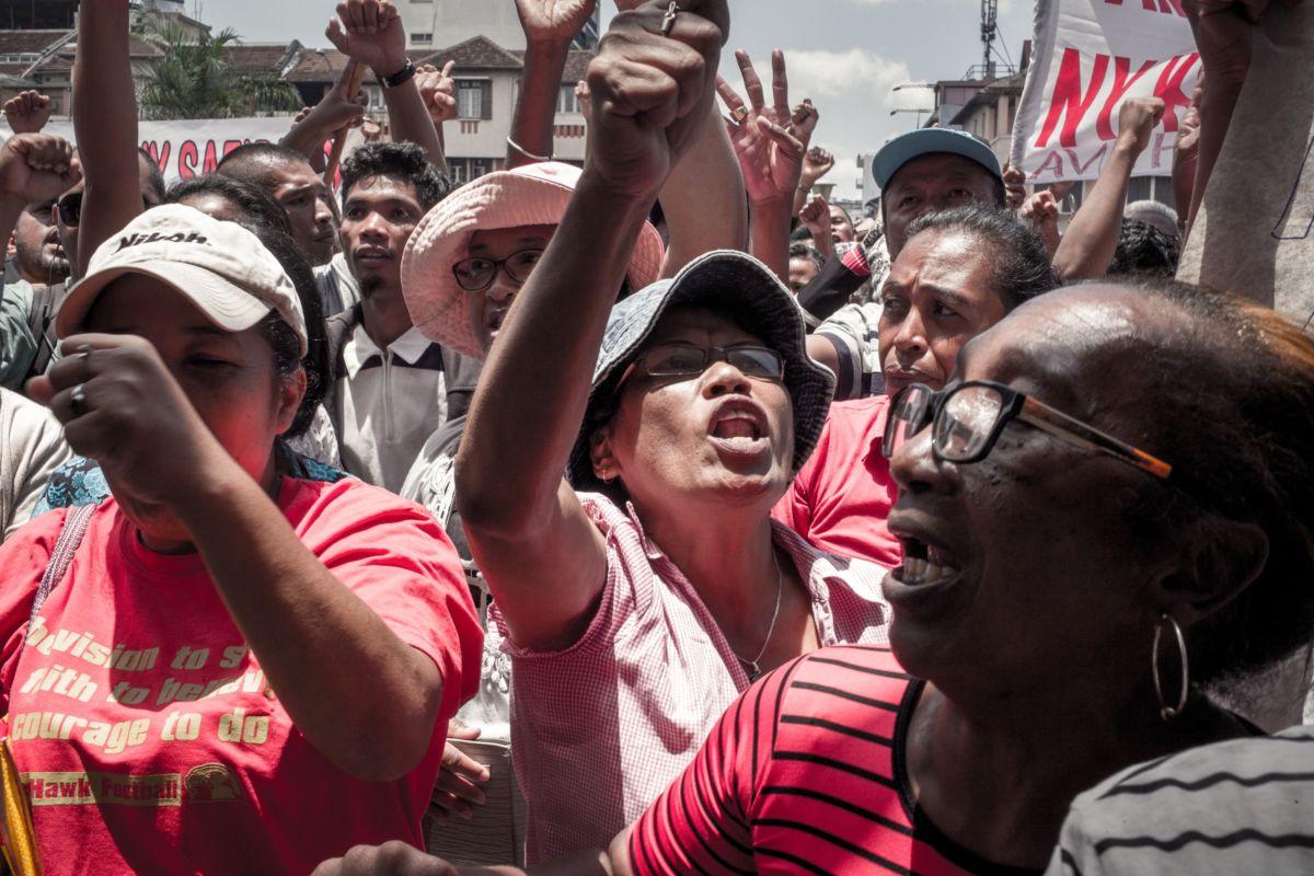 Supporters of the Malagasy opposition presidential candidate Marc Ravalomanana gesture and chant slogans during a rally at the 13 Mai Plaza, in Antananarivo, on December 29, 2018, to protest against the provisional results announced by the Independent National Electoral Commission.