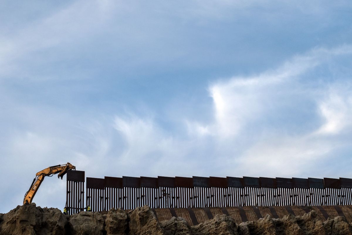 A crew works replacing the old border fence along a section of the US-Mexico border, as seen from Tijuana, in Baja California state, Mexico, on January 8, 2019.