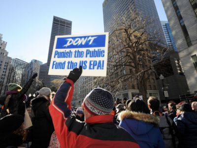 An EPA employee holds a sign during a protest rally by government workers and concerned citizens against the government shutdown on Friday, January 11, 2019, at Post Office Square near the Federal building in Boston, Massachusetts.