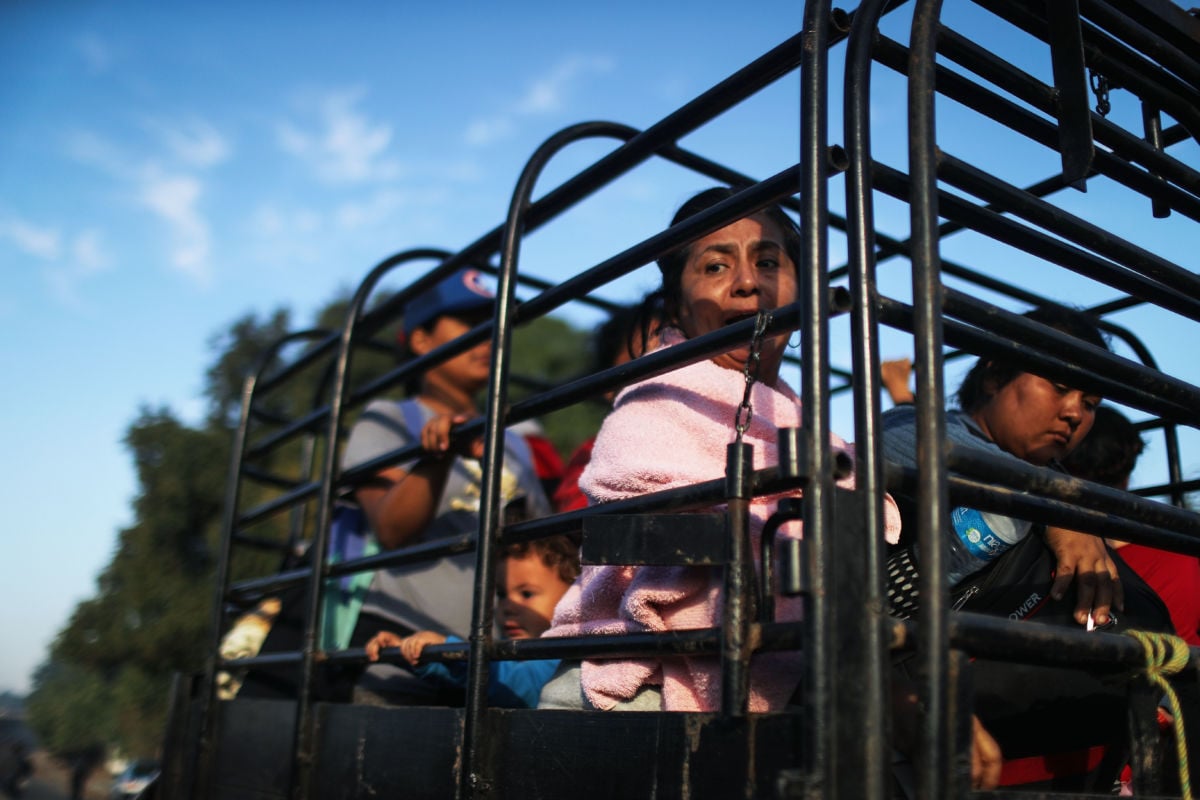 People from a caravan of Central American migrants on their way to the United States wait to depart on a truck whose driver offered a ride on January 22, 2019, in Santo Domingo Zanatepec, Mexico.