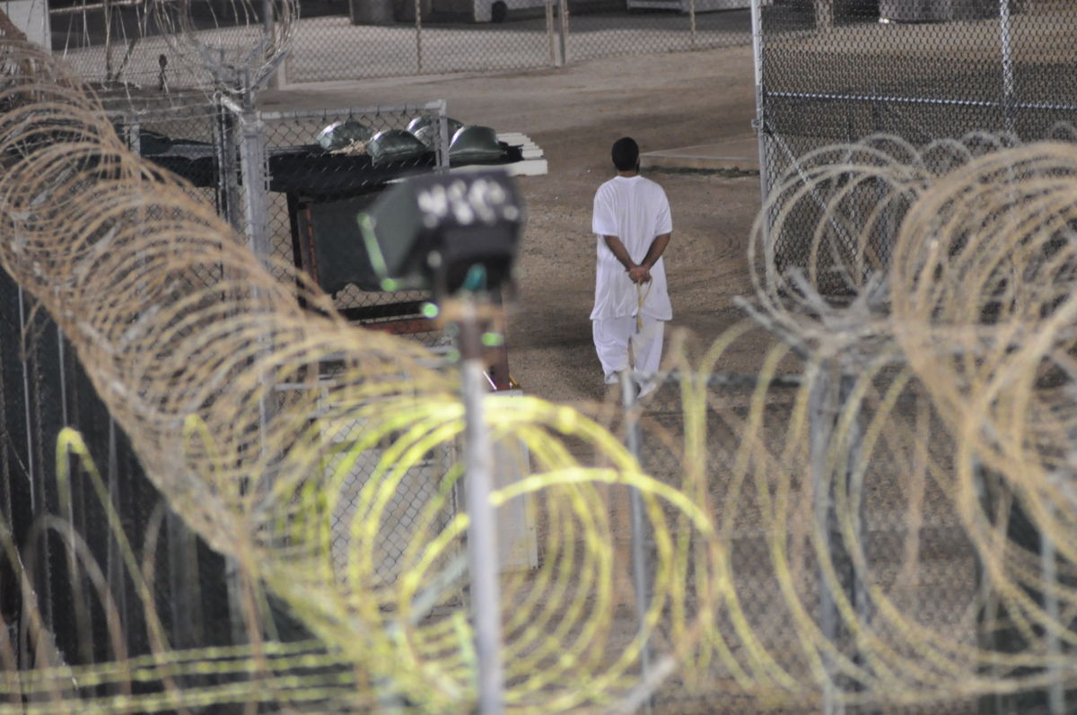 Canadian detainee Omar Khadr walks the grounds of Camp 4 in Guantanamo Bay praying before dawn in this Nov. 4, 2009, photo.