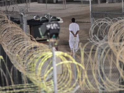 Canadian detainee Omar Khadr walks the grounds of Camp 4 in Guantanamo Bay praying before dawn in this Nov. 4, 2009, photo.