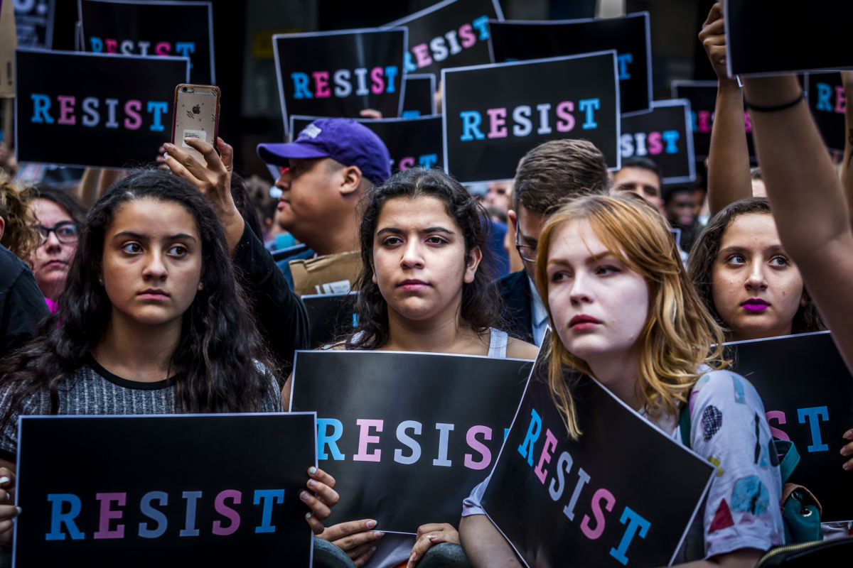 Protesters demonstrate in opposition to President Trump's tweets proposing to ban transgender people from military service during an action on July 26, 2017, in New York City.