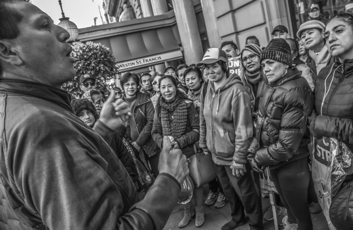 UNITE HERE Local 2 representative Rafael Leiva tells strikers at the Saint Francis Hotel that a settlement has been reached in the Marriott strike.