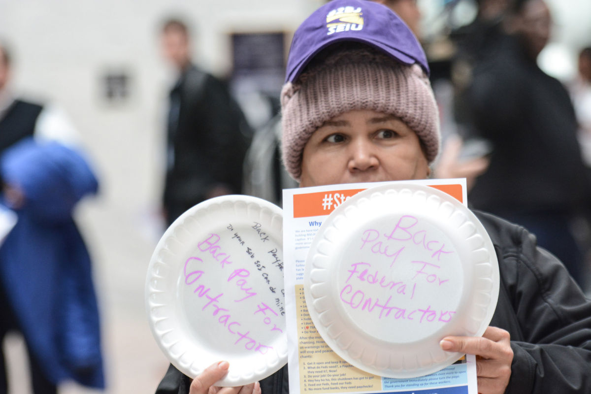 On January 23, hundreds of members of the American Federation of Government Employees, other union members, federal employees and contractors, and allies held a silent protest against the federal shutdown at the Hart Senate Office Building in Washington, DC. Among their demands was back pay for federal contractors, who currently are not eligible for it under law.