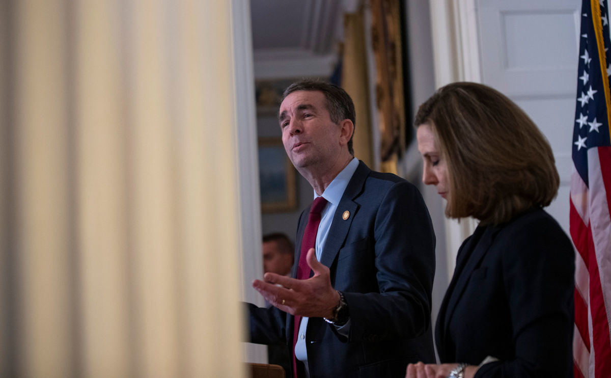 Virginia Gov. Ralph Northam, flanked by his wife Pam, speaks with reporters at a press conference at the governor's mansion on February 2, 2019, in Richmond, Virginia.