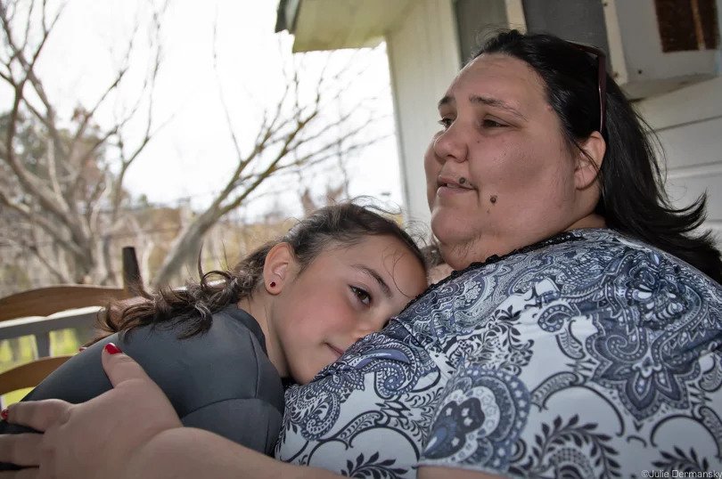 IDJC executive secretary Chantel Comardelle, with her daughter, at her grandmother’s house on the Isle de Jean Charles.