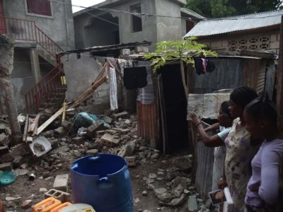 A family looks at the rubbles of their destroyed house in Gros Morne, Haiti, on October 8, 2018.
