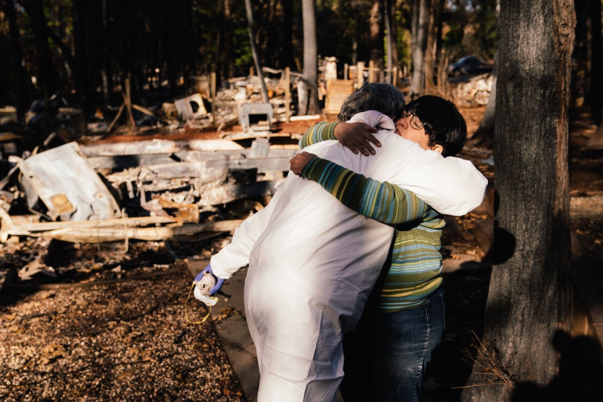 Patty Stringer hugs her neighbor of 20 years, Dee Johnson, as she says her final goodbyes at Johnson's home in Magalia, California, on December 3, 2018.