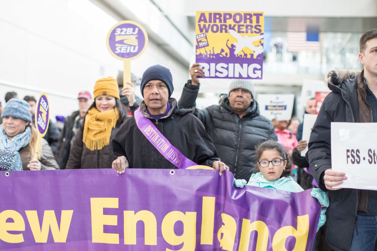 Airport workers hold signs and march during a rally for employees affected by the government shutdown at Boston Logan International Airport on January 21, 2019, in Boston, Massachusetts.