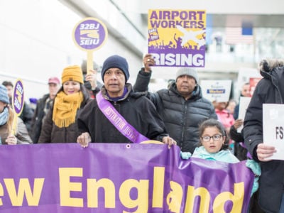 Airport workers hold signs and march during a rally for employees affected by the government shutdown at Boston Logan International Airport on January 21, 2019, in Boston, Massachusetts.