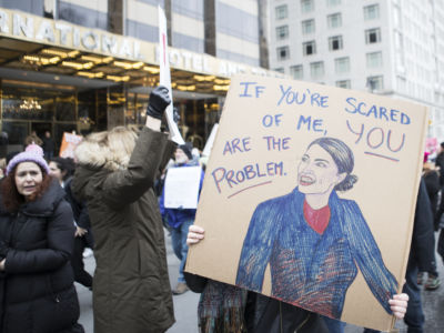 A marcher holds a sign that say, "If You're Scared of Me, You Are The Problem" with an image of Alexandria Ocasio-Cortez Democratic of the 14th congressional district of the House Of Representatives in front of Trump International Hotel during the Woman's March in the borough of Manhattan in NY on January 19, 2019.