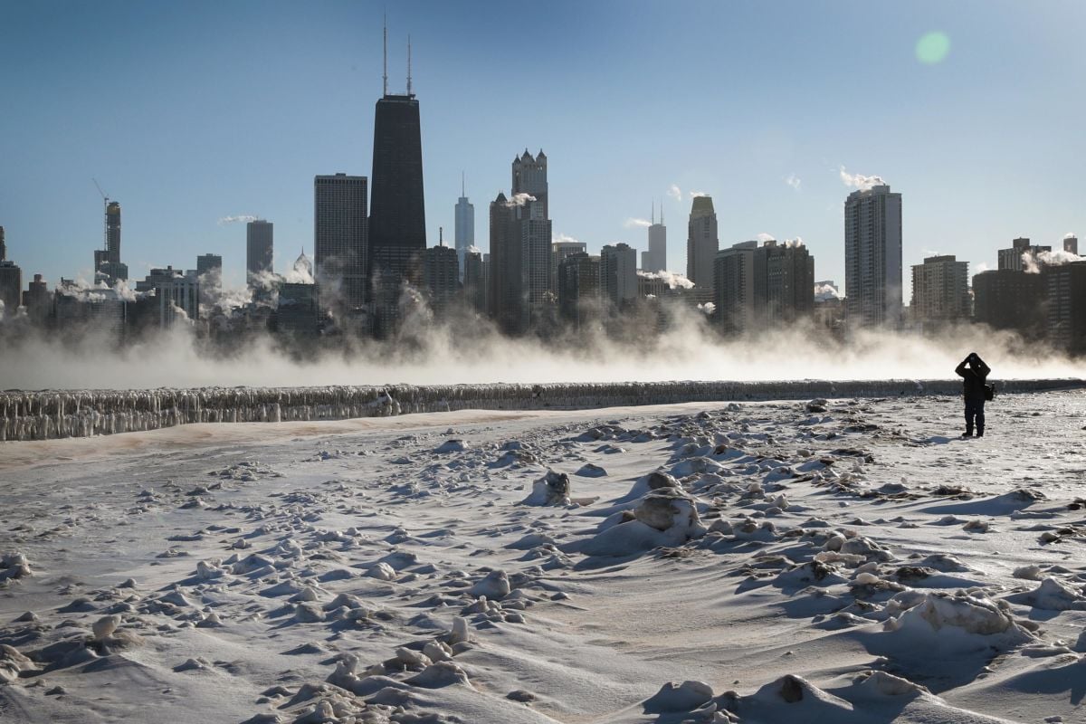 A person takes a picture of the Chicago skyline along the city's lakefront as the temperature hung around -20 degrees on January 30, 2019, in Chicago, Illinois.