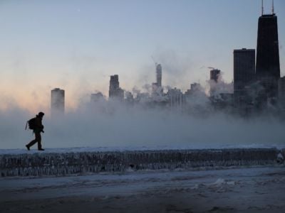 A man walks along an ice-covered breakwall along Lake Michigan while temperatures were hovering around -20 degrees and wind chills neared -50 degrees on January 31, 2019, in Chicago, Illinois.