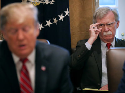 National Security Adviser John Bolton listens to President Trump talk to reporters during a meeting of his cabinet in the Cabinet Room at the White House, February 12, 2019, in Washington, D.C.