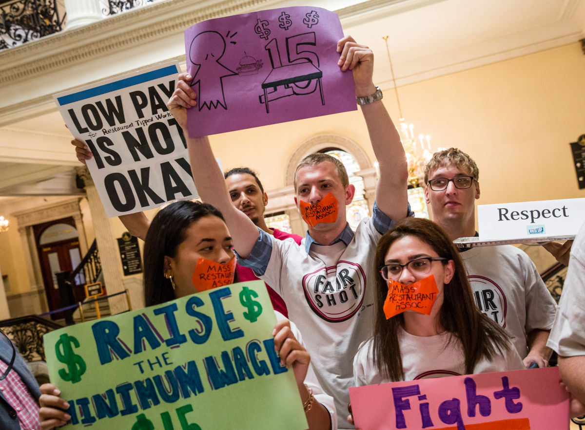 Servers and other hospitality workers that rely on tips for income take part in a rally at the Massachusetts State House in Boston to convince lawmakers to raise the $3.75 minimum wage for restaurant workers on June 12, 2018.