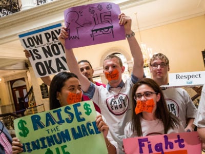 Servers and other hospitality workers that rely on tips for income take part in a rally at the Massachusetts State House in Boston to convince lawmakers to raise the $3.75 minimum wage for restaurant workers on June 12, 2018.