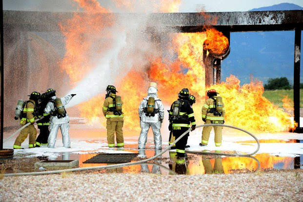 Firefighters at Peterson Air Force Base conduct live training with AFFF. Notice the grassy area just beyond the foam. July 21, 2014.