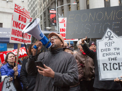 Protestors demonstrate against the 2017 tax bill on December 19, 2017, on Wall Street in New York City.