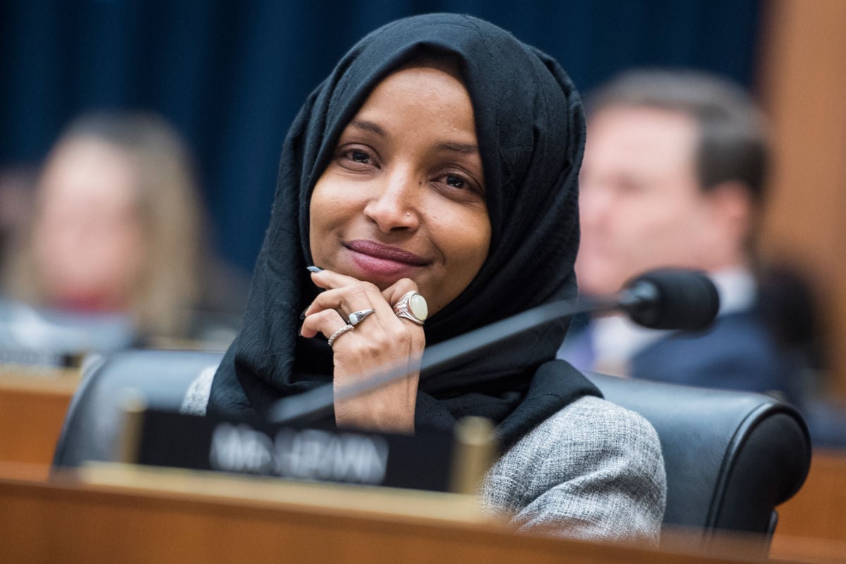 Rep. Ilhan Omar listens during Congressional meeting