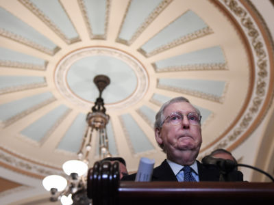 Mitch Mcconnell stands at a podium.