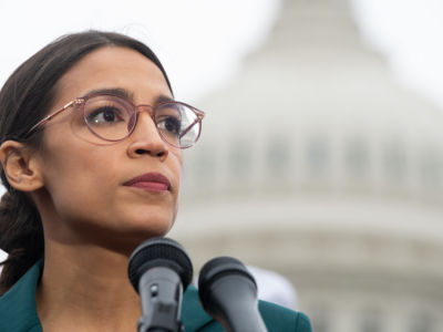 Rep. Alexandria Ocasio-Cortez looks stern at an event