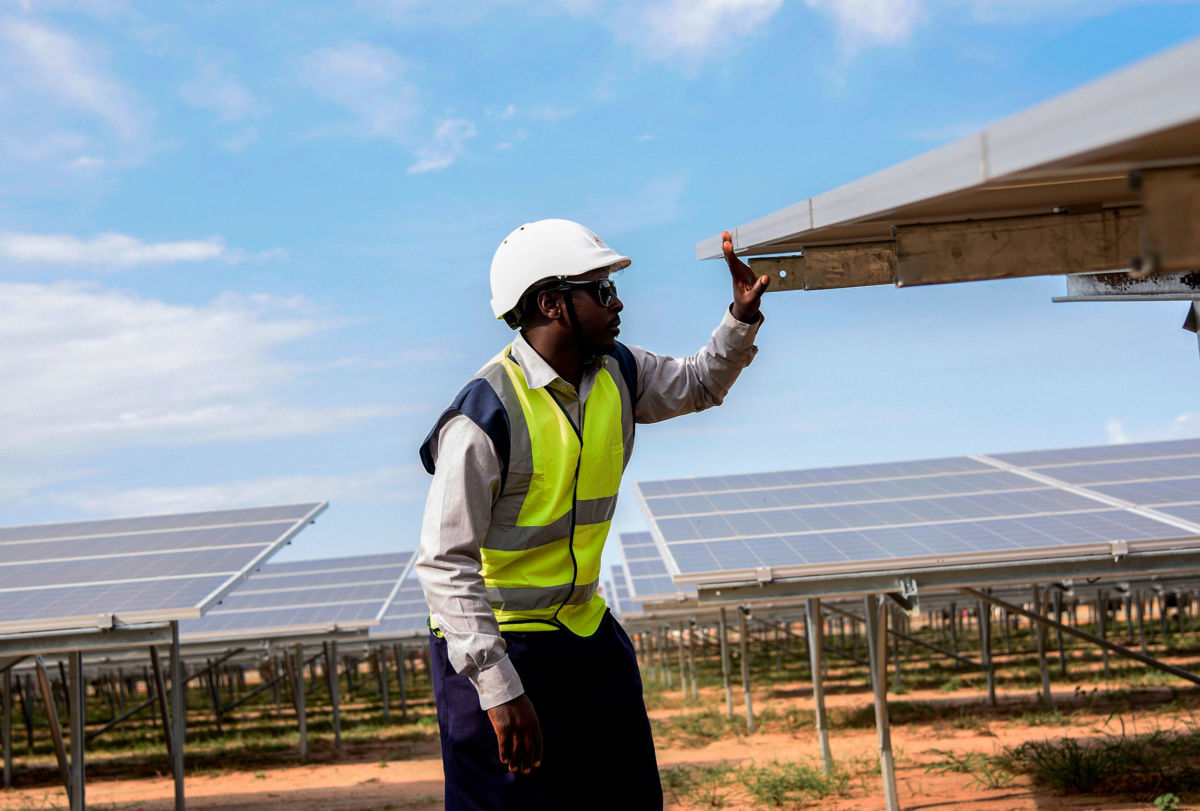 An engineer works on solar panels in Soroti District