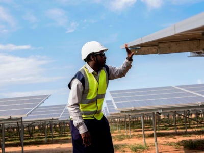An engineer works on solar panels in Soroti District